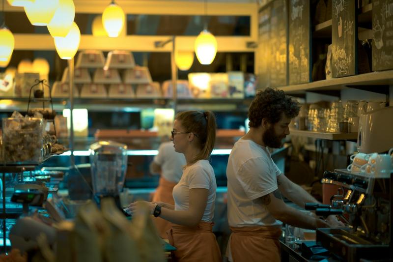 Staff serving behind a cafe counter
