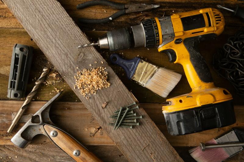 Drill, hammer and tools on a workbench